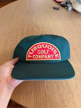 Turquoise golf company hat